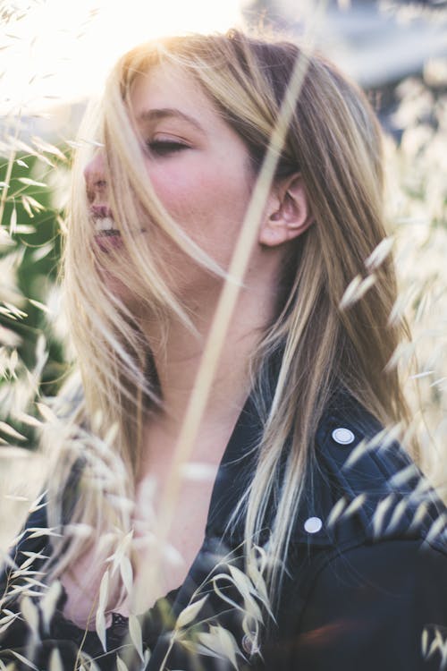 Free Close-up Side View Photo of Smiling Woman in Black Top  and Jacket Posing With Her Eyes Closed Stock Photo