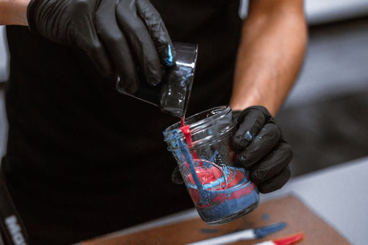 Photo Of Person Combining Acrylic Paints In Mason Jar