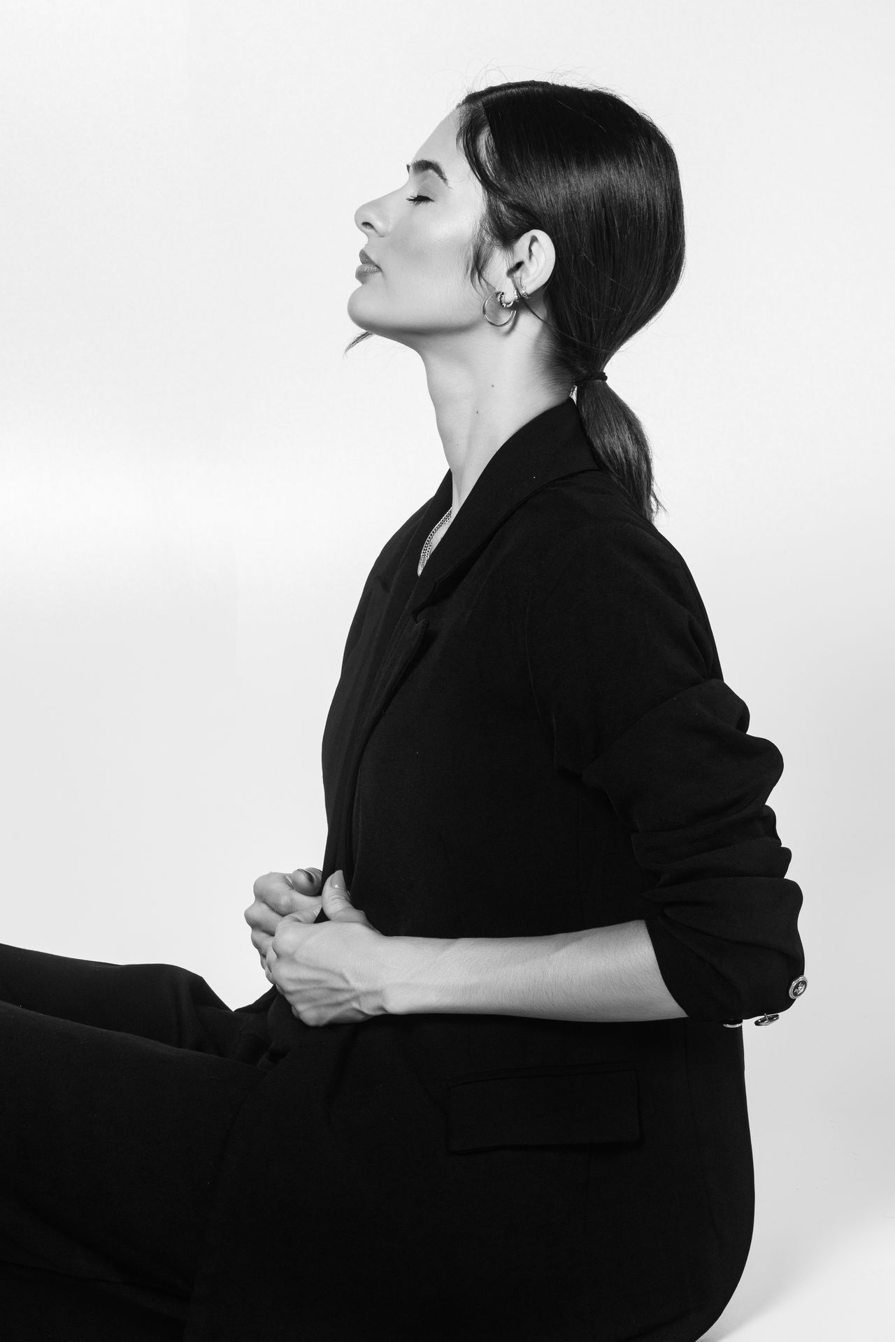 Black-and-white profile portrait of a woman in a black blazer