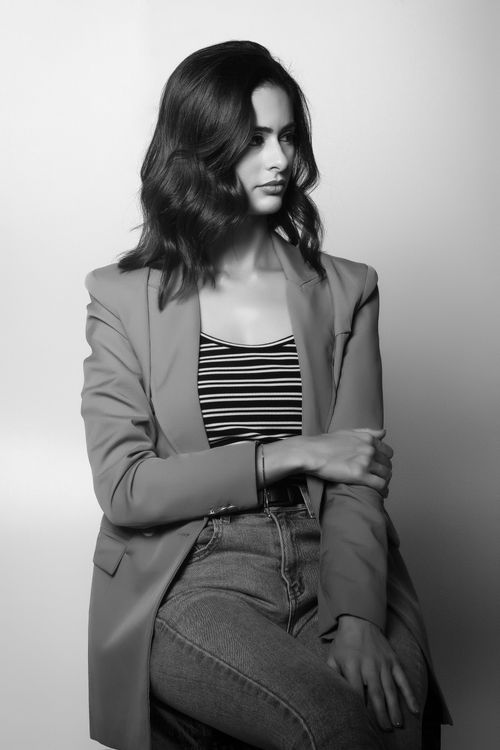 Free Chic black and white portrait of a woman in a blazer striking a thoughtful pose Stock Photo