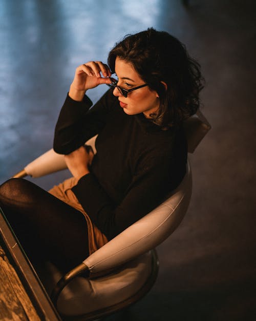 High Angle Photo of Woman Sitting on Chair