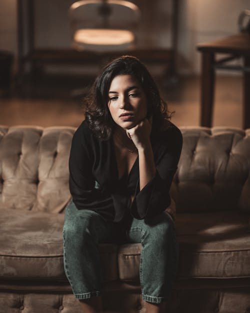 Woman Sitting on Sofa