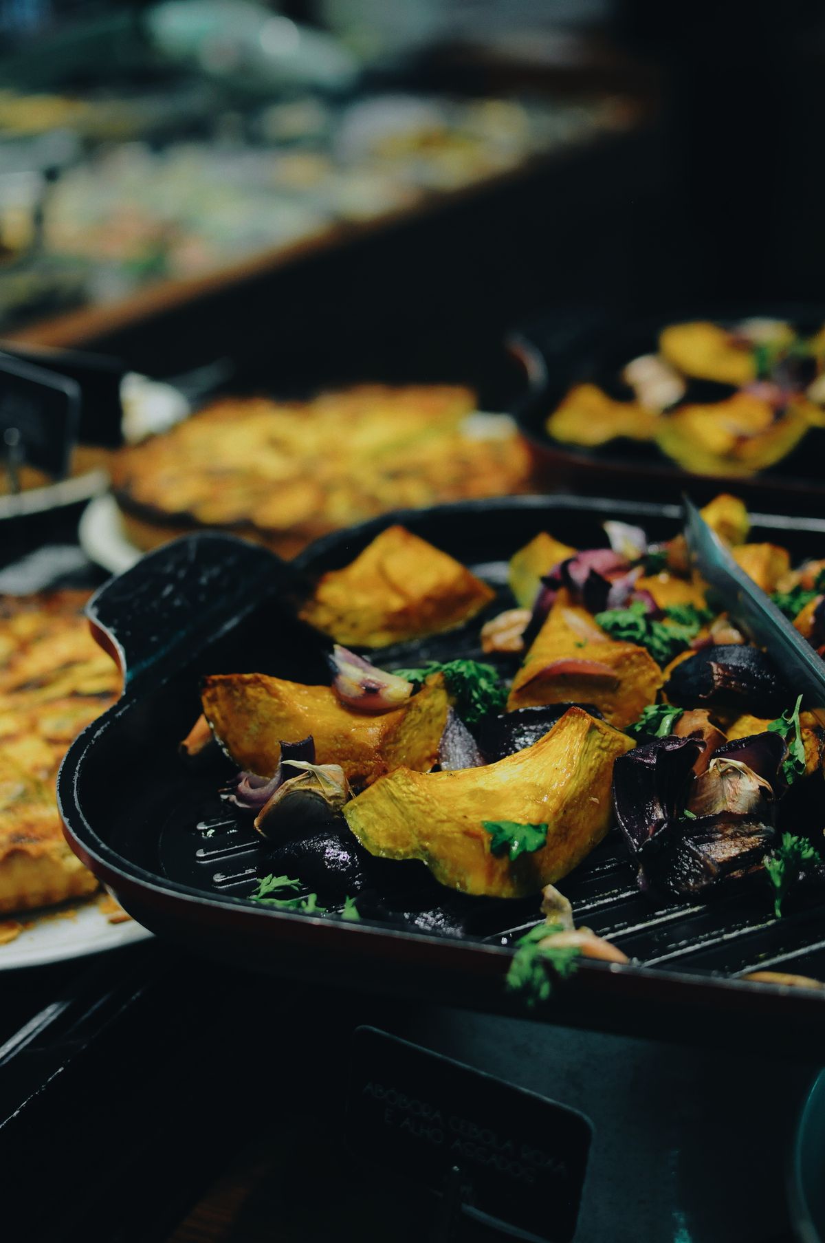 Cast iron skillet filled with roasted vegetables for cookware buying guidance