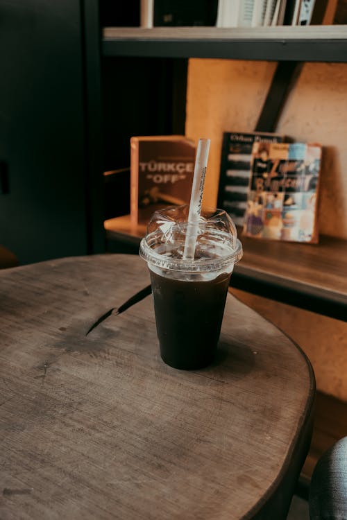 A black coffee cup sitting on a wooden table