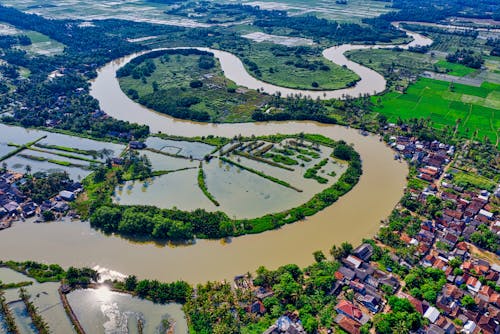 Aerial View of River Near Houses and Trees