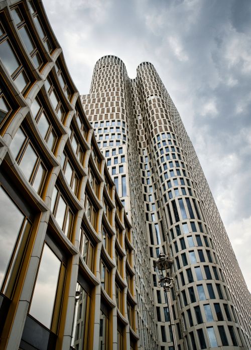 Free Striking modern architecture of a Berlin skyscraper against a cloudy sky. Stock Photo