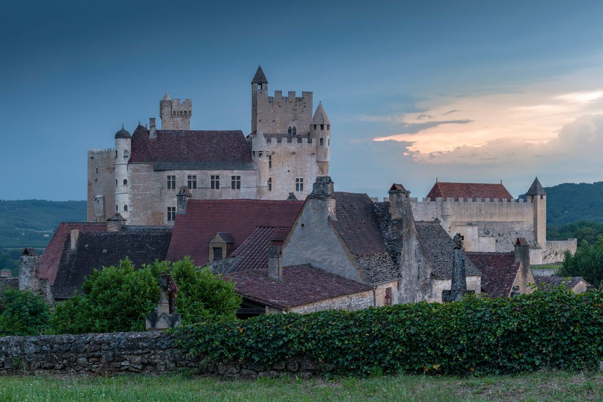 The medieval fortress of Beynac at dusk above its village