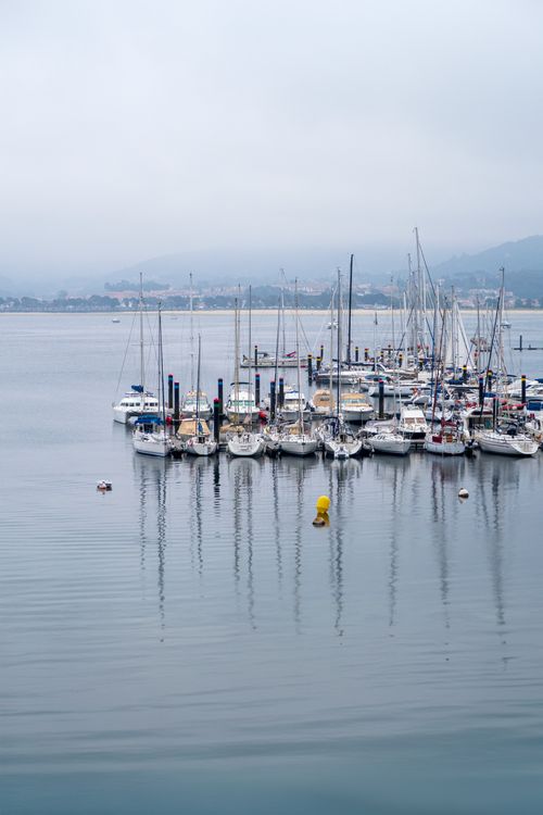 Free Calm marina scene with yachts moored on a misty day. Stock Photo