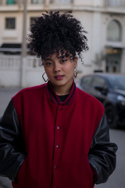 A woman with curly hair wearing a red jacket