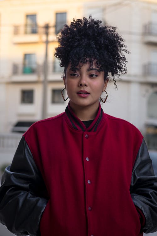 A woman with curly hair wearing a red jacket