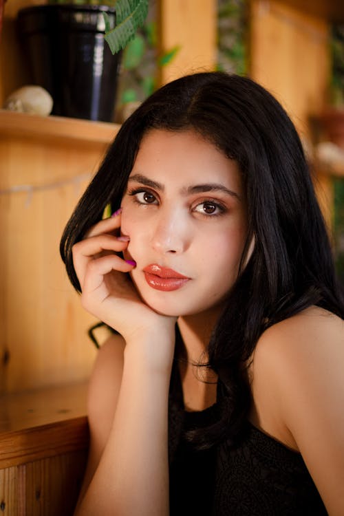 A woman with long black hair and red lipstick