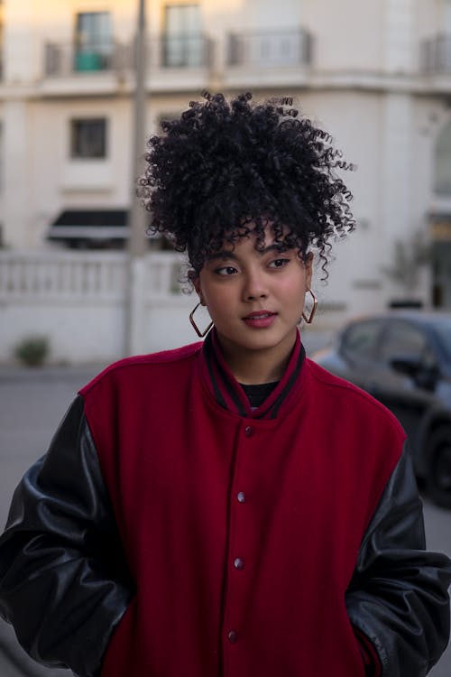 A woman with curly hair wearing a red jacket