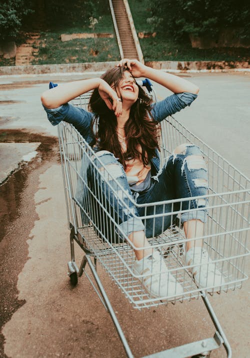 Free Photo of Woman Sitting in Shopping Cart Stock Photo