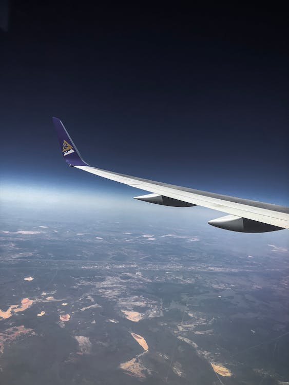 Free White Airplane wing in the sky Stock Photo