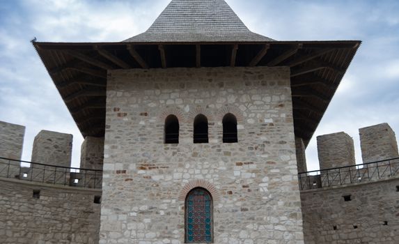 Close-up of Soroca Castle's stone tower with clear sky, showcasing medieval architecture.
