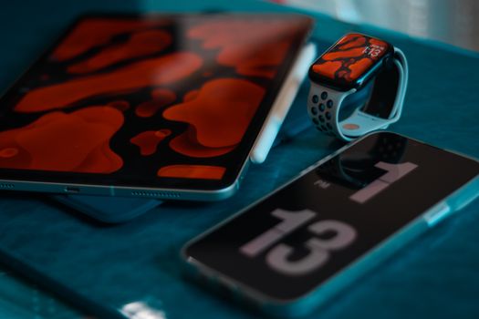 A collection of modern tech gadgets including a smartphone, smartwatch, and tablet, creatively displayed.