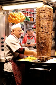 Street market vendor cooking kebab with fresh ingredients in a busy setting.