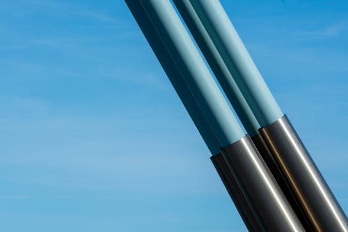 Two metal poles with blue and silver tips