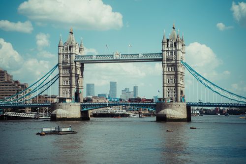 Free Iconic Tower Bridge in London stands tall over the River Thames under a bright blue sky. Stock Photo