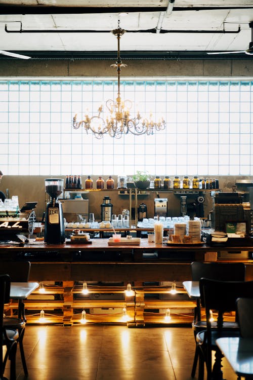 A restaurant with a chandelier hanging from the ceiling