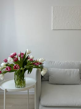 A stylish and elegant living room featuring a tulip bouquet in a modern minimalist design.