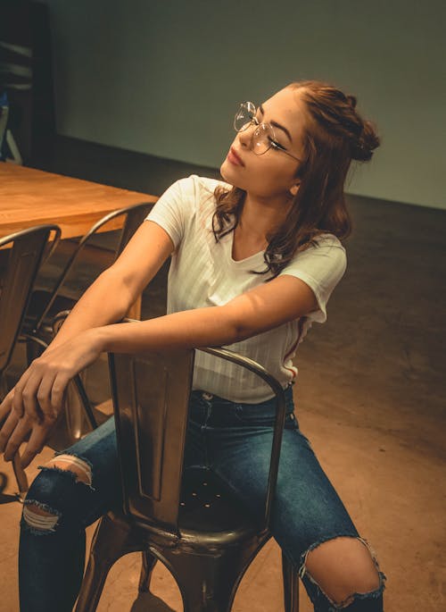 Free Photo of Woman Sitting on Chair Stock Photo