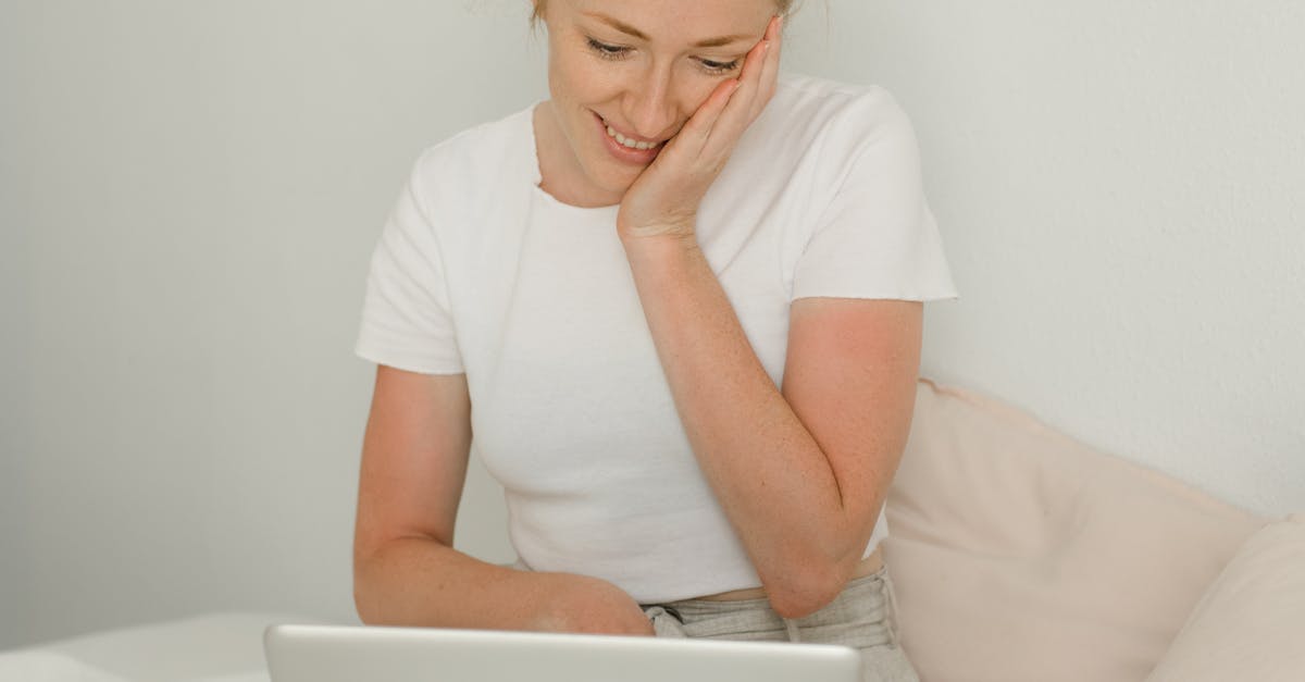 A laptop showing an educational video with animated graphics and subtitles.