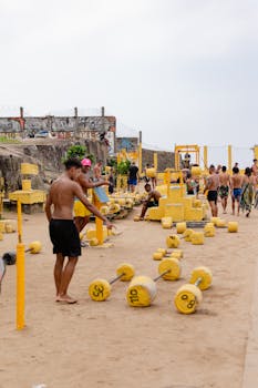 People exercising at an outdoor gym on Rio's sandy beach, showcasing vibrant fitness activities.
