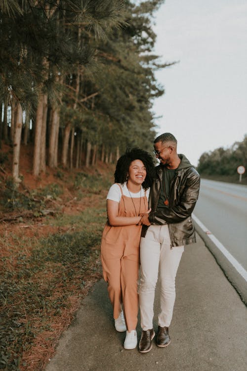 A couple standing on the side of the road