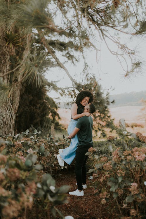 A couple embracing in the woods during their engagement session