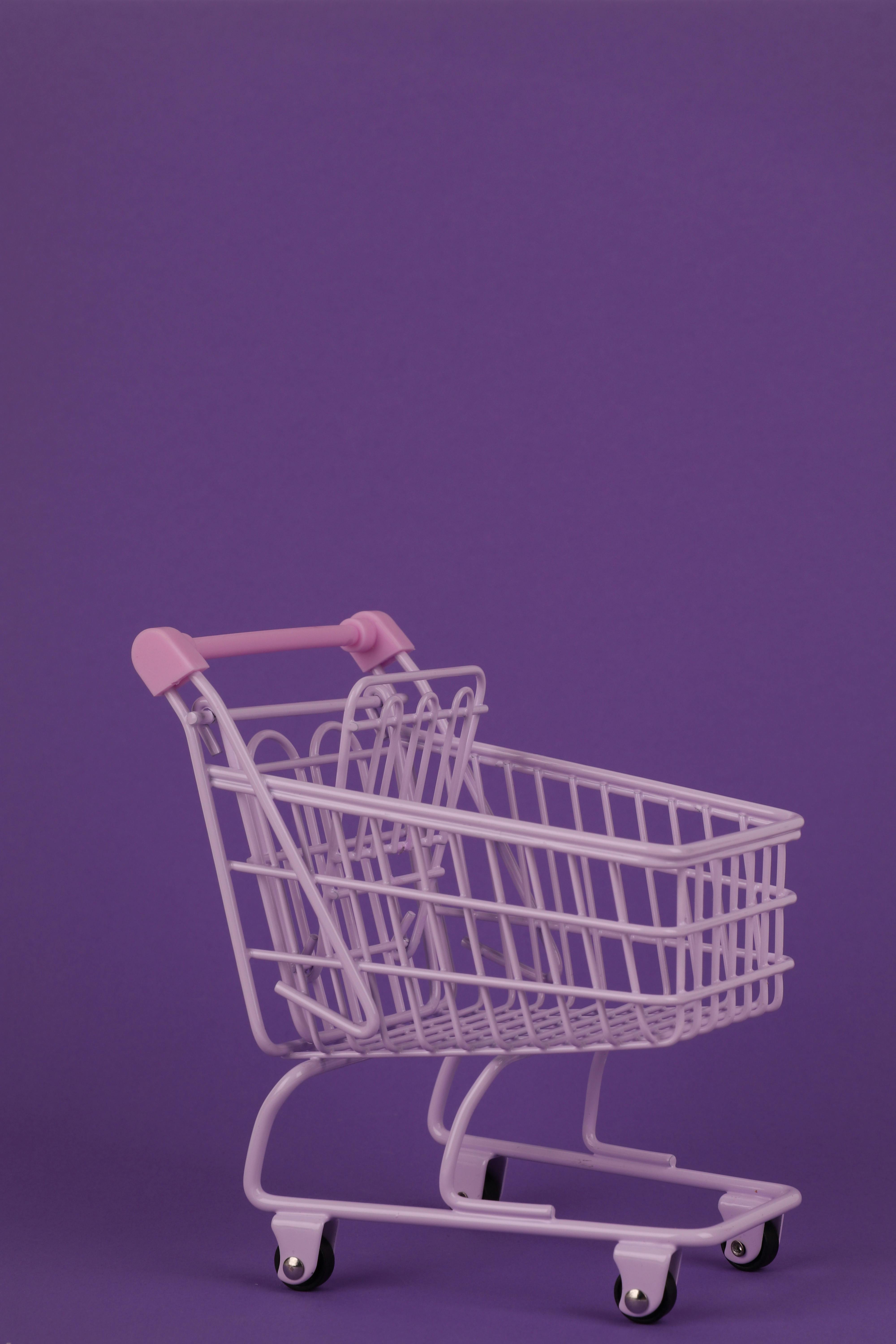 Vibrant purple shopping cart with ample copy space, perfect for retail themes.