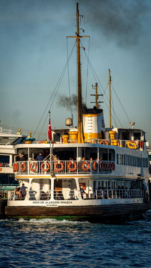 Free Historic Istanbul ferry navigating busy harbor under clear daylight. Stock Photo