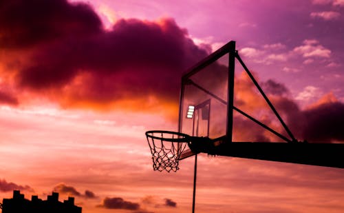 Silhouette Photo of Basketball Hoop During Golden Hour