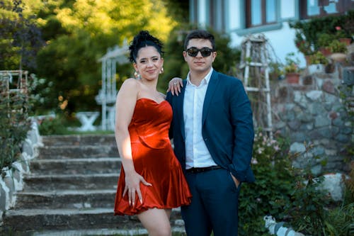 A man and woman in formal wear posing for a photo