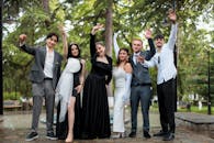 Group of Well-Dressed Friends Waving at the Camera