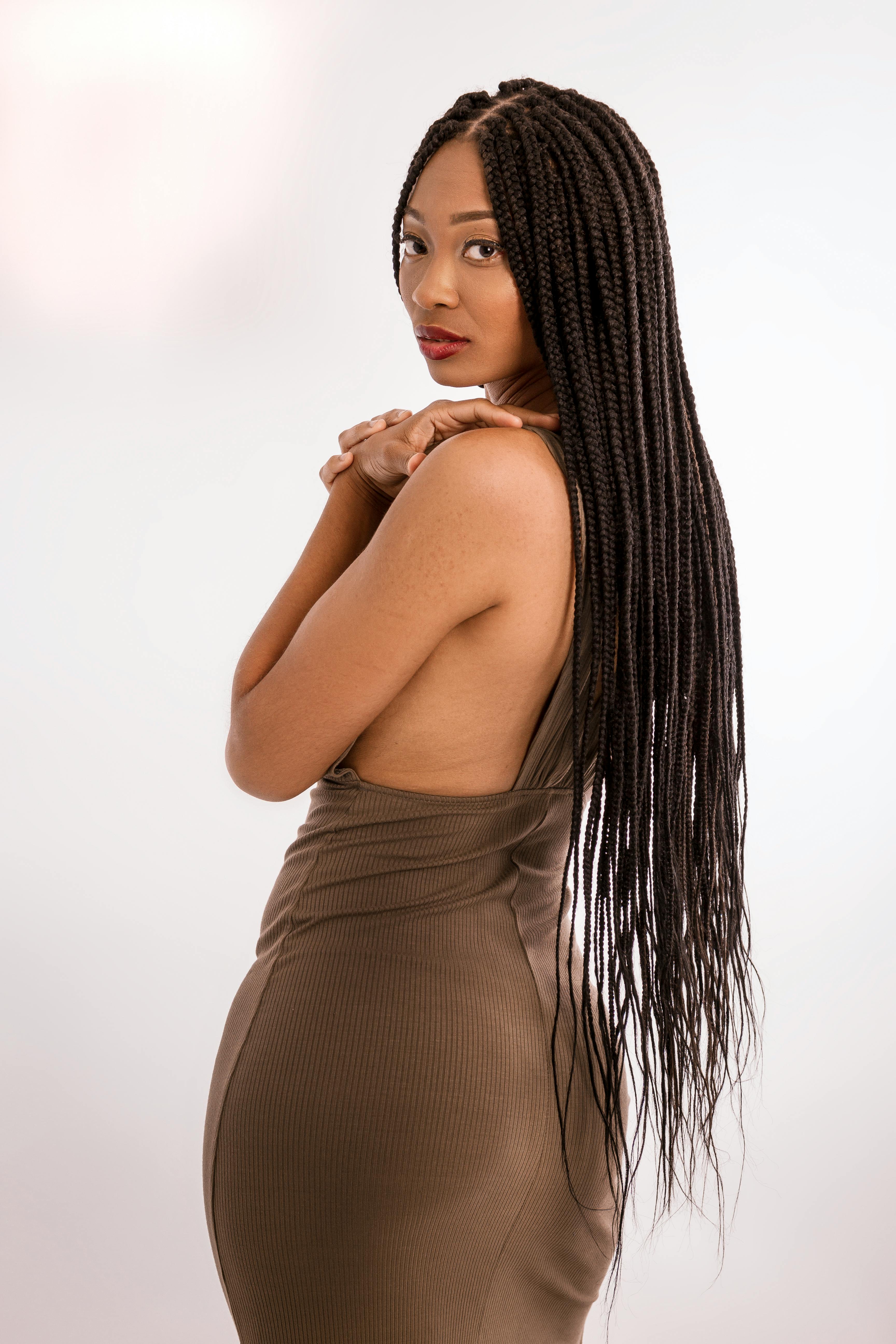 photo of woman wearing brown dress