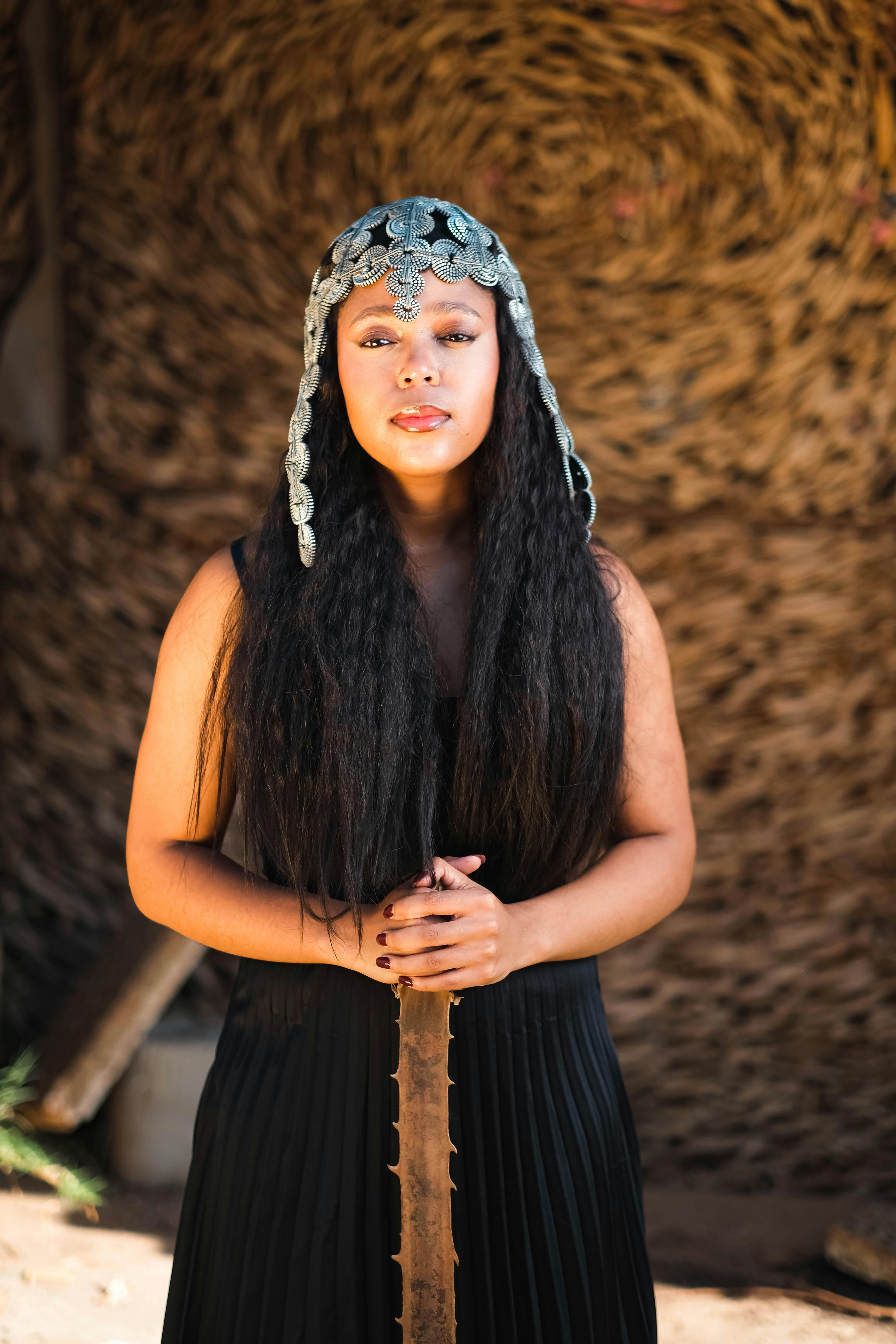 A striking portrait of a woman wearing a medieval-style headdress, exuding elegance and mystery.