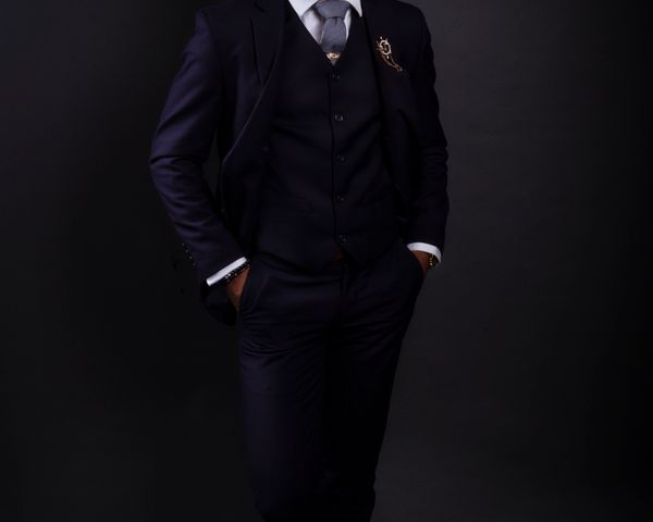 Man wearing black three piece suit with waistcoat