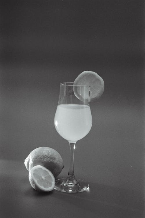 A black and white photo of a glass of lemonade