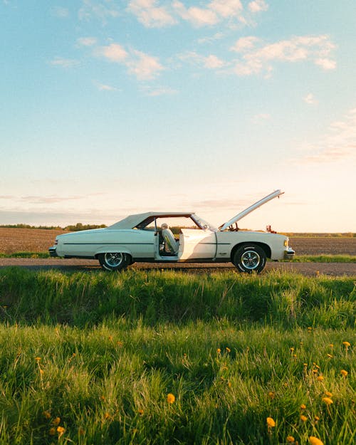 A white car parked on the side of the road