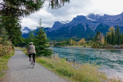 Rear View of Woman Walking on Mountain Road