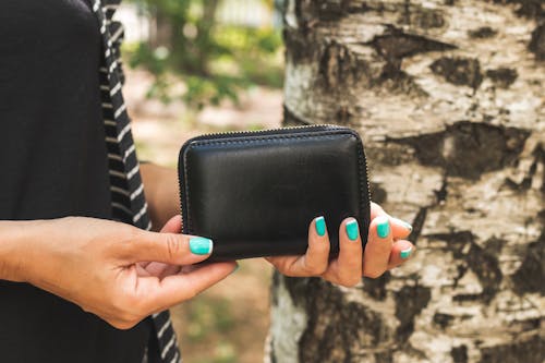Free Photo of Woman Holding Black Leather Wallet Stock Photo