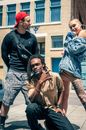 Three Person Standing Near White and Brown Building