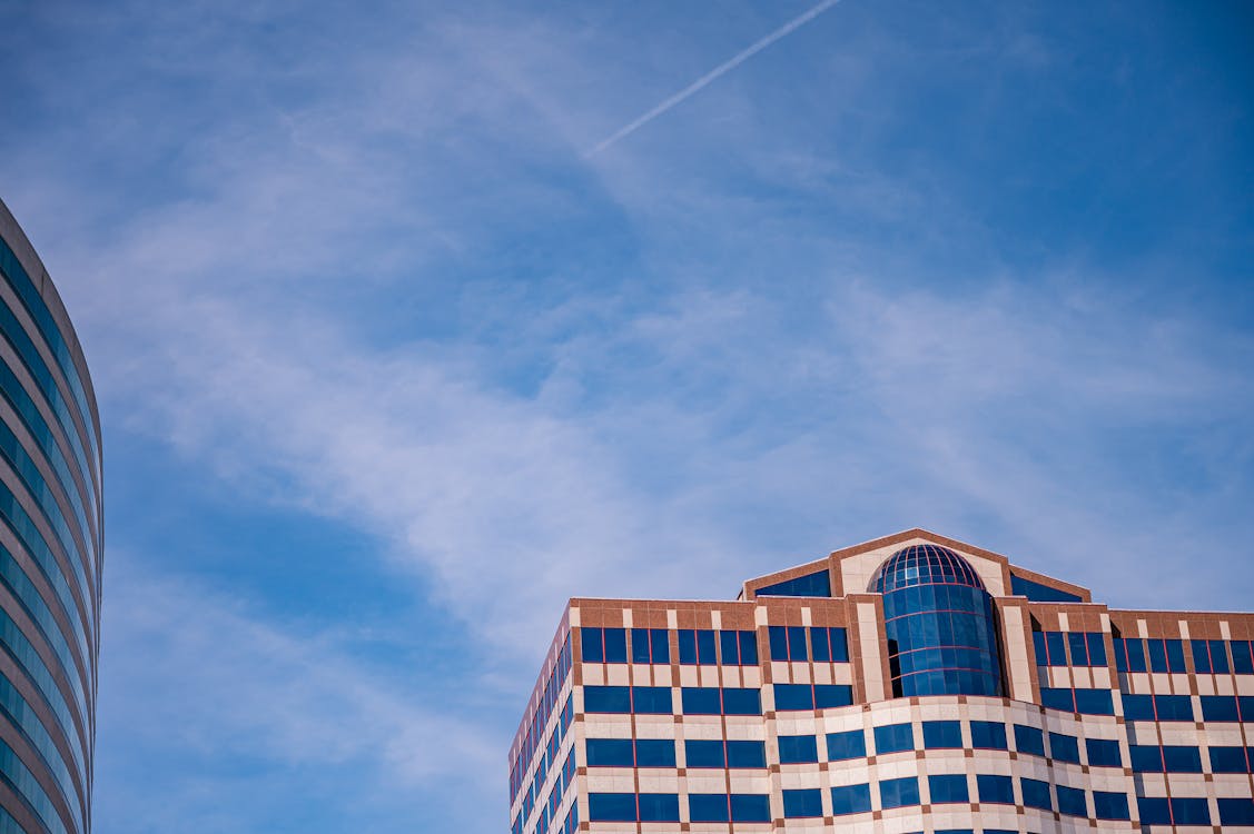 Free Low Angle Photo of Building Under Cloudy Sky Stock Photo