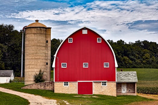 Picturesque red barn with silo in Cross Plains, WI, showcasing rural charm.
