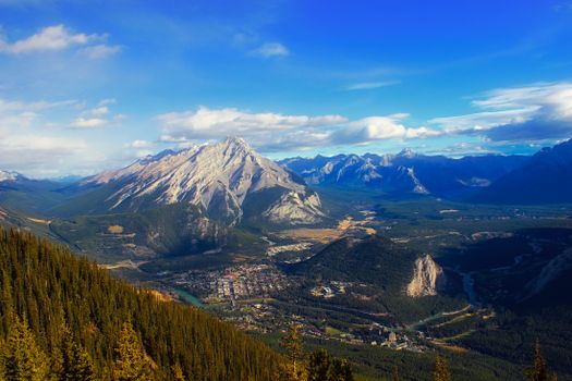 Scenic aerial view of the majestic mountains and lush forests in Banff, Canada.
