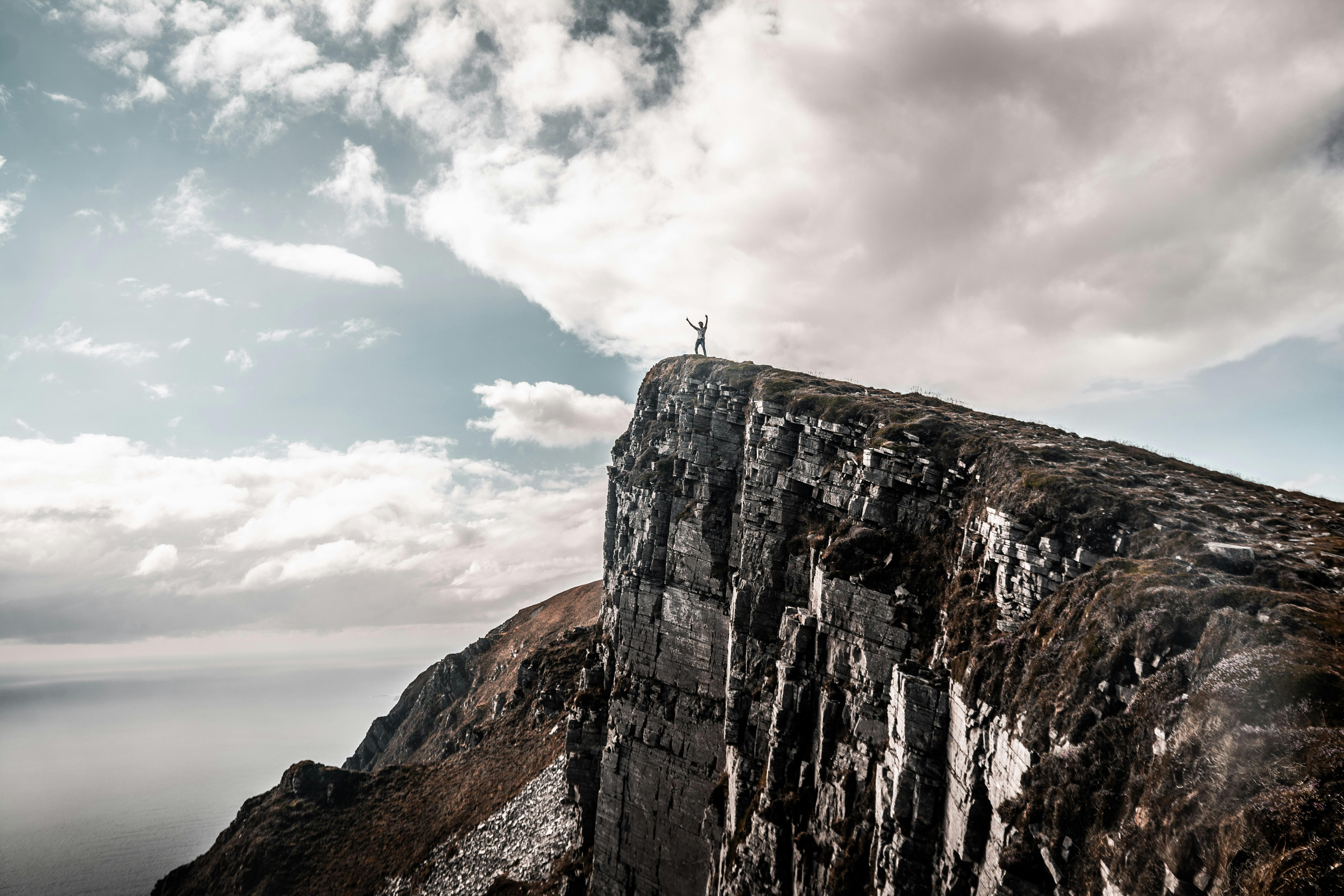 Men On A Cliff Stock Photo - Download Image Now - Cliff, Falling, At The  Edge Of - iStock