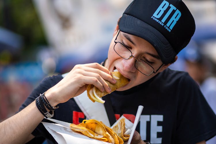 A Young Man Eating Street Food 