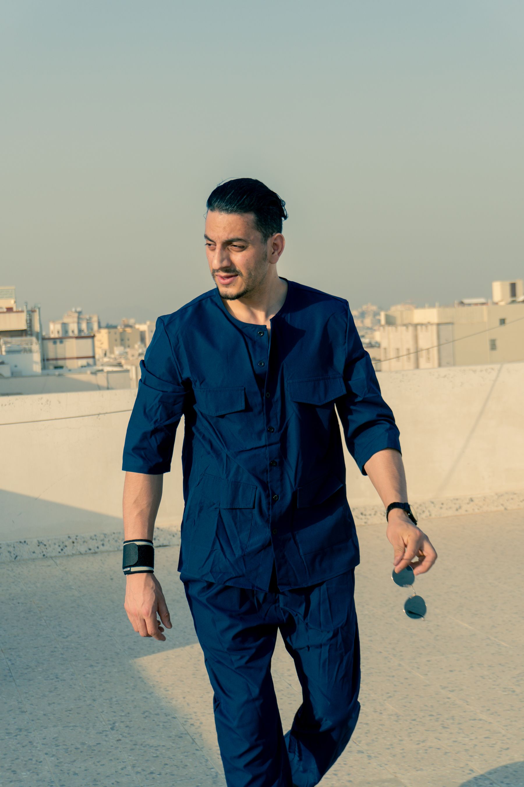 A Fashionable Man Posing on a Terrace · Free Stock Photo