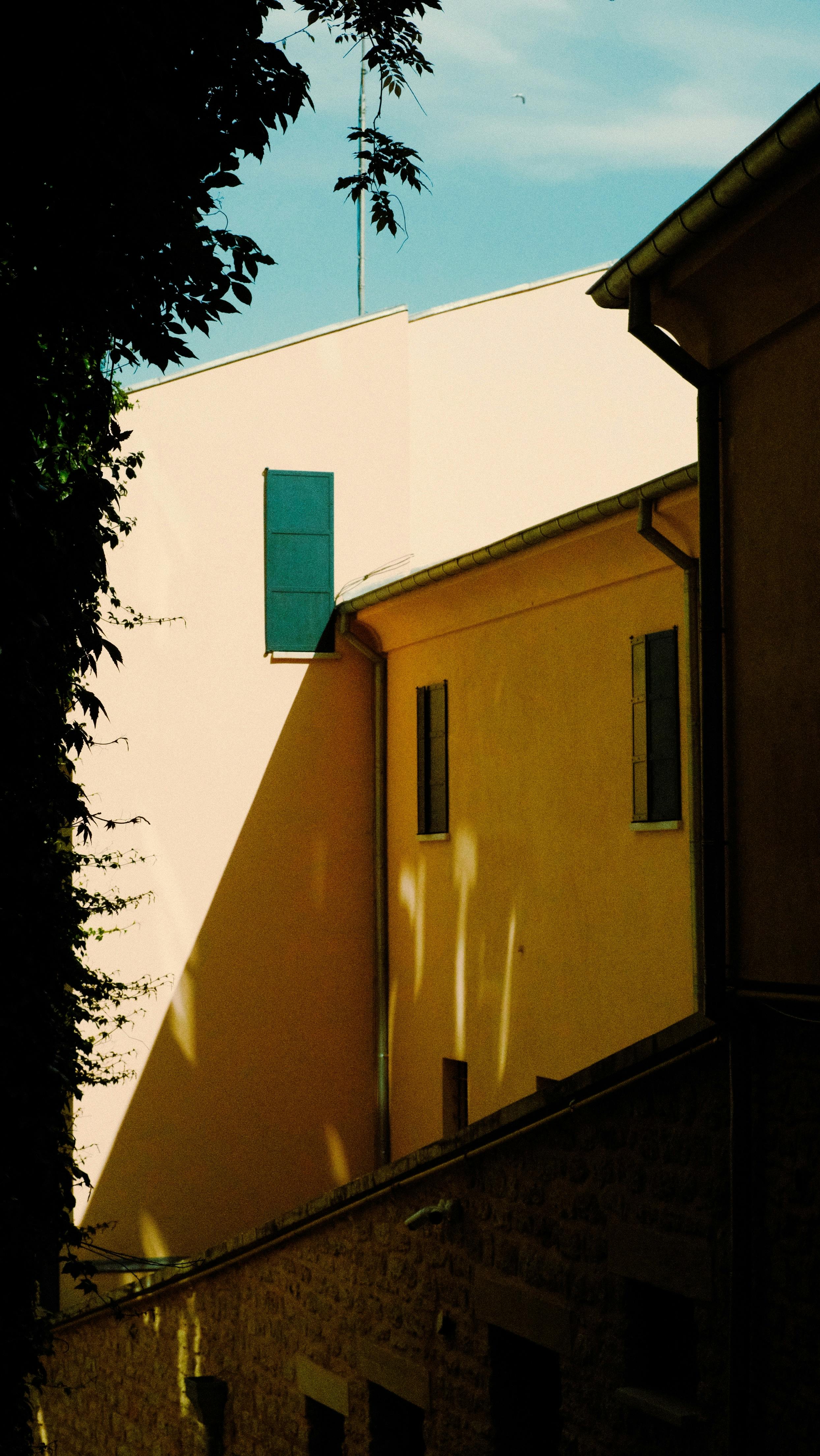 Yellow urban building in İstanbul with striking shadows and light contrast.